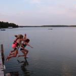 Kids jumping into the lake